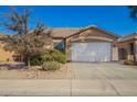 Charming single-story home with desert landscaping and a two-car garage at 46072 W Barbara Ln, Maricopa, AZ 85139