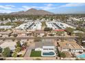 Stunning aerial view of home with in-ground pool and beautiful desert landscaping at 5927 E Edgemont Ave, Scottsdale, AZ 85257