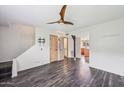 Spacious living room with hardwood floors, ceiling fan and access to the kitchen at 6169 N Granite Reef Rd, Scottsdale, AZ 85250