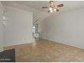 Open living room with tile flooring, a ceiling fan, and natural light, providing a bright and inviting atmosphere at 6711 W Osborn Rd # 127, Phoenix, AZ 85033