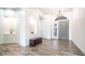 Inviting foyer with wood-look tile flooring and an elegant chandelier at 737 E Boston St, Gilbert, AZ 85295