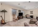 Spacious living room featuring plush seating, neutral walls, and a ceiling fan for added comfort at 76 N 133Rd St, Chandler, AZ 85225