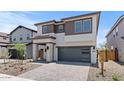 Inviting two-story home with a paver driveway and a charming facade featuring a mix of stone and siding at 7987 W Griswold Rd, Peoria, AZ 85345