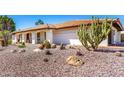 Single-story home featuring a barrel tile roof, desert landscape, and a covered front porch at 9234 N 33Rd Way, Phoenix, AZ 85028