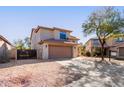 View of the two story home with low maintenance front yard and a two car garage at 9413 W Pioneer St, Tolleson, AZ 85353