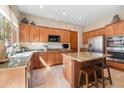 Spacious kitchen with stainless steel appliances, granite countertops, an island, and wooden cabinetry at 11489 N 141St St, Scottsdale, AZ 85259