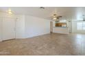 Spacious living room featuring neutral walls, tile flooring, and a ceiling fan at 13011 W Mandalay Ln, El Mirage, AZ 85335