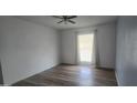 Cozy bedroom showcasing wood-look floors and a bright window with natural light at 13816 N 103Rd Ave, Sun City, AZ 85351