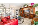 Bright living room showcasing tile floors, large windows, and a stately built-in entertainment center at 15377 W Cheery Lynn Rd, Goodyear, AZ 85395