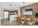 Open-concept dining room with warm tones and kitchen access at 16800 E El Lago Blvd # 2072, Fountain Hills, AZ 85268