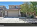 Charming two-story home featuring a two-car garage, landscaped yard, and inviting front porch at 16881 W Monroe St, Goodyear, AZ 85338