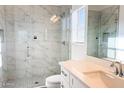 Modern bathroom featuring a glass enclosed shower with marble tile surround and quartz counters at 16917 E Dixileta Dr, Rio Verde, AZ 85263