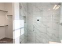 Contemporary shower featuring a glass enclosure, marble tile surround and built-in niche at 16917 E Dixileta Dr, Rio Verde, AZ 85263