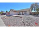 Single-story home with low-maintenance desert landscaping and a cozy front porch bench at 1753 E Shasta St, Casa Grande, AZ 85122