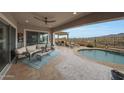 Inviting back patio with a lounge area, outdoor dining, and a refreshing pool at 19051 N 259Th Ave, Buckeye, AZ 85396