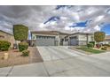 Single Gathering home with a two-car garage, ample driveway space, and manicured landscaping at 19736 E Emperor Blvd, Queen Creek, AZ 85142