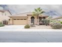 Charming single-story home featuring a desert-style front yard and stylish stone accents at the front entryway at 203 S La Amador Trl, Casa Grande, AZ 85194