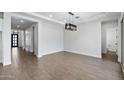 Spacious living room with modern light fixture and tile flooring at 20979 E Mayberry Rd, Queen Creek, AZ 85142