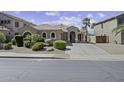 Charming single-story home featuring a well-manicured front yard with mature landscaping at 22346 N Goles Dr, Maricopa, AZ 85138