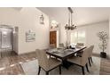 Inviting dining room featuring a stylish chandelier and a beautifully set table, perfect for gatherings at 2415 Leisure World --, Mesa, AZ 85206