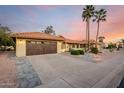 Beautiful single-story home featuring a desert landscape, tile roof, and an attached two-car garage at 2415 Leisure World --, Mesa, AZ 85206