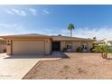 Inviting single-story home with a well-maintained yard and desert landscaping, showcasing curb appeal at 25620 S Cloverland Dr, Sun Lakes, AZ 85248