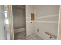 Bathroom in progress, featuring a new tub with built in shelving and unpainted walls at 2707 E Abe Truckle Ave, San Tan Valley, AZ 85140