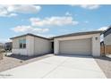 Charming home featuring a spacious driveway, perfect for parking, and a two-car garage at 2707 E Abe Truckle Ave, San Tan Valley, AZ 85140