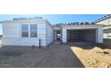 Exterior view of a single-Gathering home featuring an attached two-car garage and an unfinished roof at 2707 E Abe Truckle Ave, San Tan Valley, AZ 85140