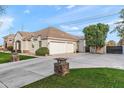 A ranch-style home featuring a three-car garage and extra long driveway that allows plenty of parking at 2838 E Vaughn Ct, Gilbert, AZ 85234