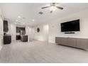 Open-concept living room and kitchen with tile flooring and modern gray cabinets for storage at 3225 W Fremont Rd, Phoenix, AZ 85041