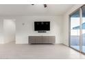 Spacious living room with tile flooring, modern cabinets and a sliding glass door to the backyard at 3225 W Fremont Rd, Phoenix, AZ 85041