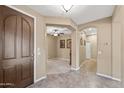 Inviting foyer with tile flooring, showcasing arches leading to the living areas and bedrooms at 398 W Honey Locust Ave, San Tan Valley, AZ 85140