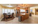 Well-lit eat-in kitchen featuring stainless steel appliances, granite countertops, and a cozy dining area at 508 W Harmont Dr, Phoenix, AZ 85021