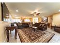 Expansive living room with tiled floors, a ceiling fan, and an open floor plan connected to the kitchen at 508 W Harmont Dr, Phoenix, AZ 85021