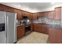 Contemporary kitchen with granite countertops, stainless steel appliances, and abundant wood cabinetry at 9455 E Raintree Dr # 2032, Scottsdale, AZ 85260