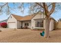 Inviting front exterior of the home features desert landscaping, quaint porch, and a charming rope swing at 1018 E Tonto Ln, Phoenix, AZ 85024