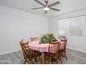 Bright dining area with wood table, seating for six, and views through the window at 10228 W Andover Ave, Sun City, AZ 85351