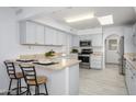 Well-lit kitchen featuring stainless steel appliances, breakfast bar, and ample counter space at 10228 W Andover Ave, Sun City, AZ 85351