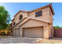 Two-story home featuring a two-car garage, neutral colors, and desert landscaping at 10452 E Florian Ave, Mesa, AZ 85208