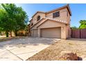 Two-story home featuring a two-car garage, neutral colors, and desert landscaping at 10452 E Florian Ave, Mesa, AZ 85208