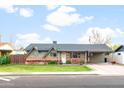 Lovely single-story home featuring a well-maintained lawn, brick details, and covered carport, blending charm and functionality at 1109 E 8Th St, Mesa, AZ 85203