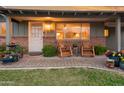 Inviting front porch with brick accents, potted plants, and rocking chairs, creating a cozy and welcoming entrance at 1109 E 8Th St, Mesa, AZ 85203