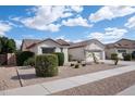 Attractive single-story home with low maintenance desert landscaping and sidewalk at 11207 N 165Th Ave, Surprise, AZ 85388