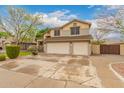 Attractive two-story home with a three-car garage, and well-maintained front yard at 1165 E Erie St, Gilbert, AZ 85295