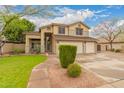 Beautiful two-story home featuring lush lawn, mature trees, and spacious three-car garage at 1165 E Erie St, Gilbert, AZ 85295