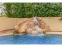 Pool featuring a rock waterfall and slide at 1165 E Erie St, Gilbert, AZ 85295