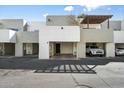 Townhome exterior showcasing stucco facade, covered parking and well-kept landscaping at 122 S Hardy Dr # 6, Tempe, AZ 85281