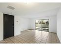 Bright, airy living room featuring sliding glass doors and tile flooring at 122 S Hardy Dr # 6, Tempe, AZ 85281