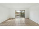 Open living space with tile flooring and sliding glass doors to the patio at 122 S Hardy Dr # 6, Tempe, AZ 85281